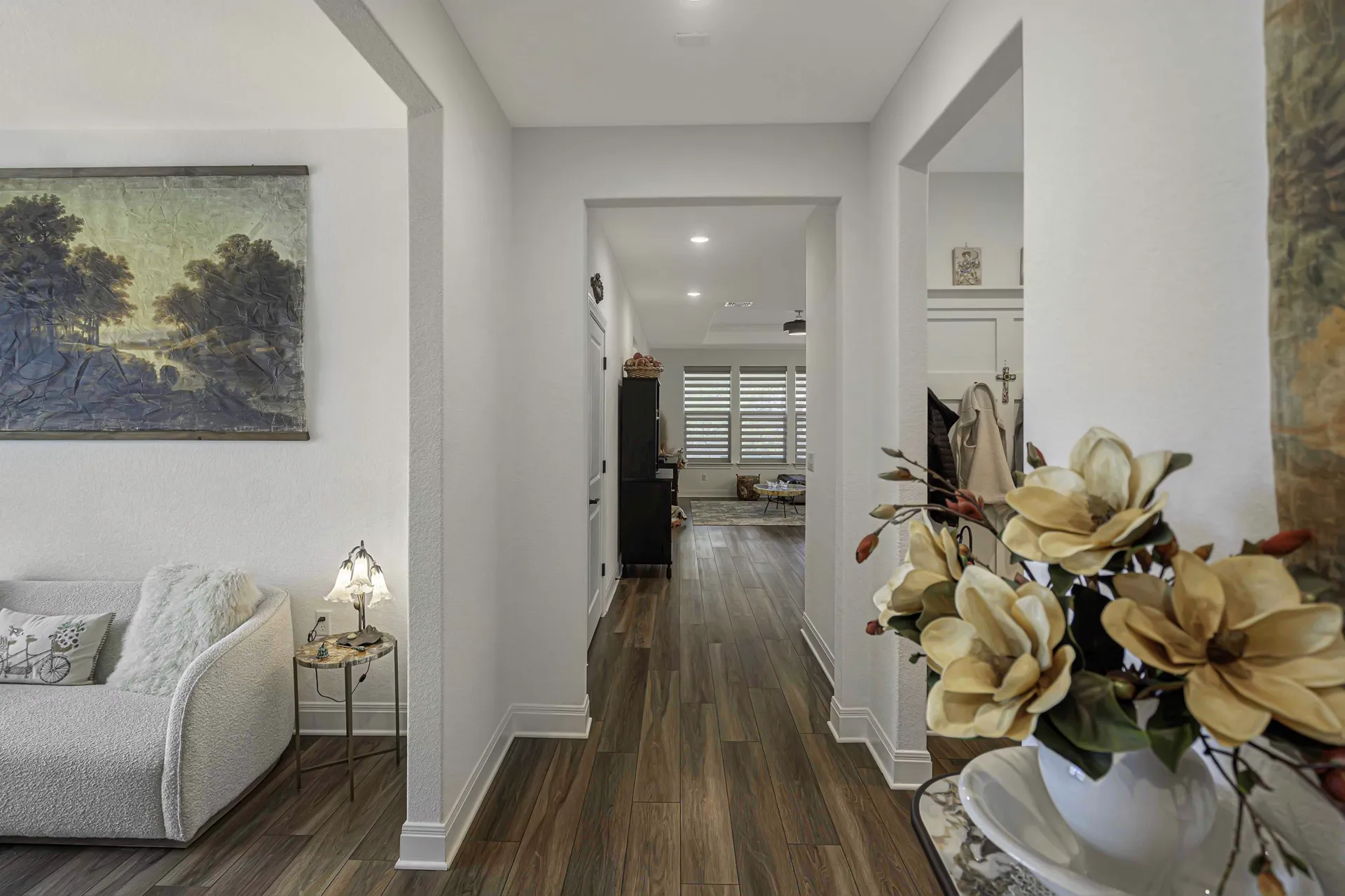 Living space with couch, open hallway and modern finishes