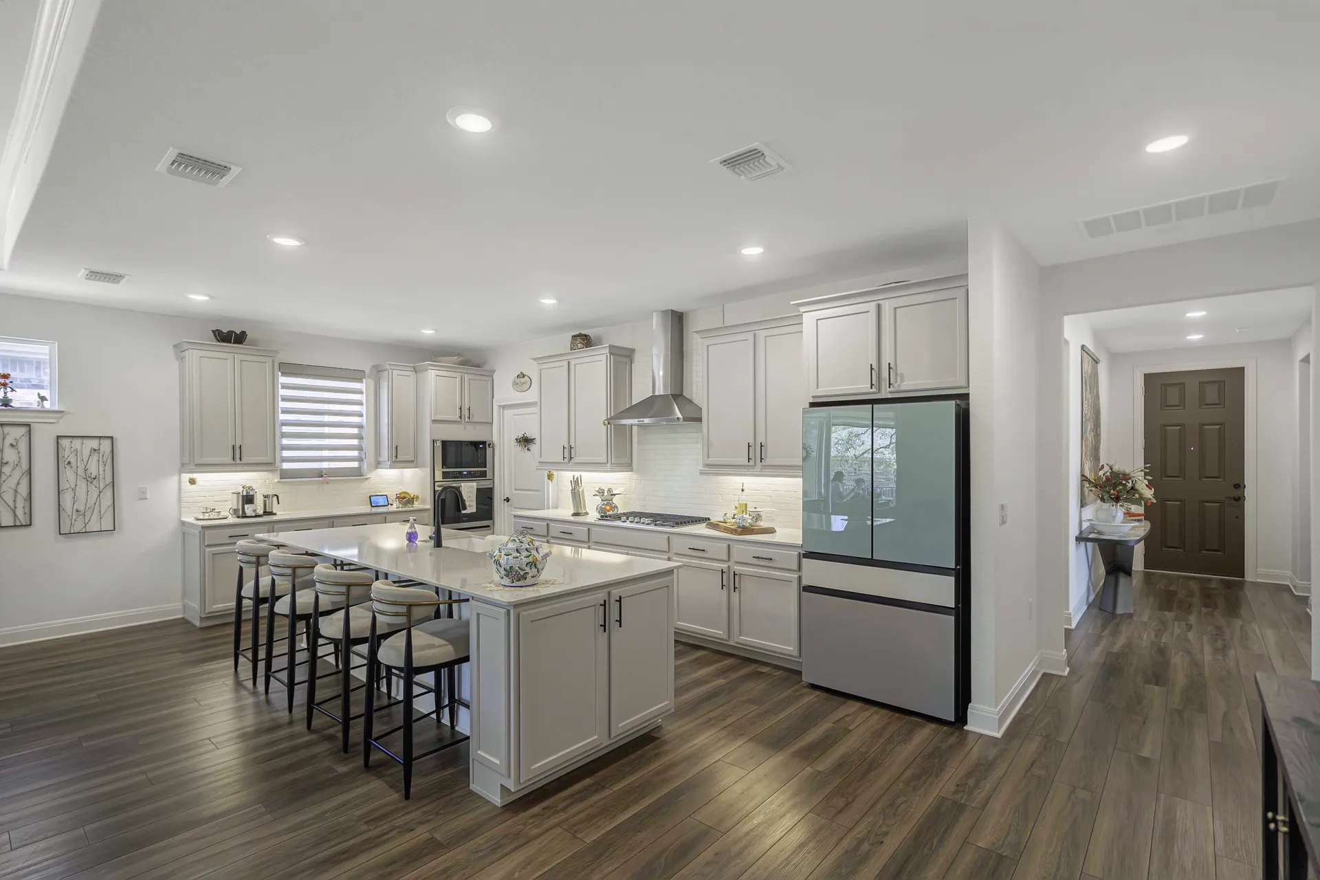Gas cooktop on island with cutting board and designer finishes